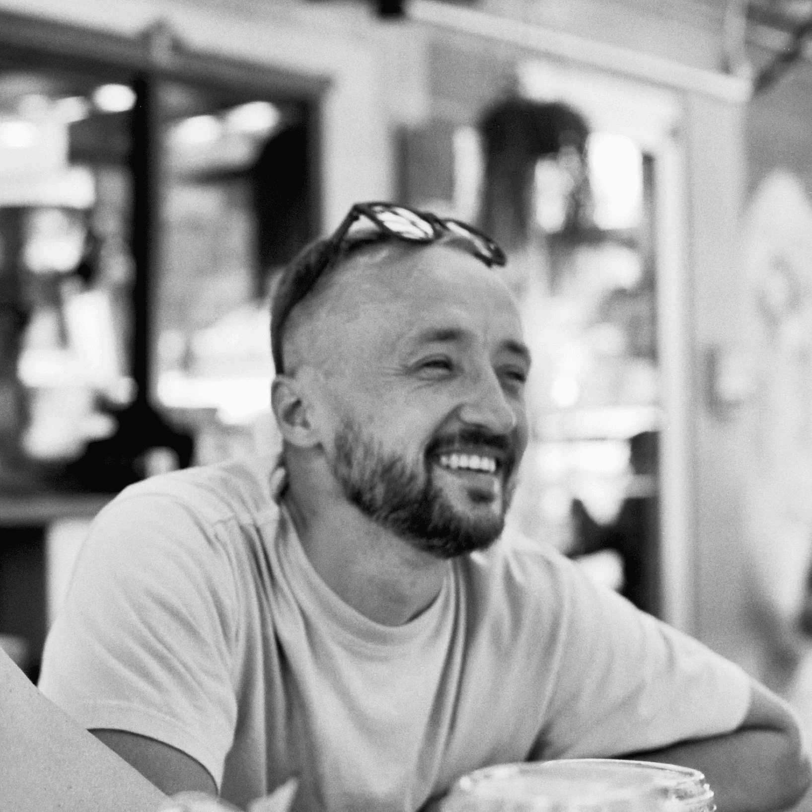 Me, laughing at a table in a café.