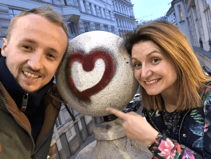 Me and my wife smiling next to a graffiti heart.